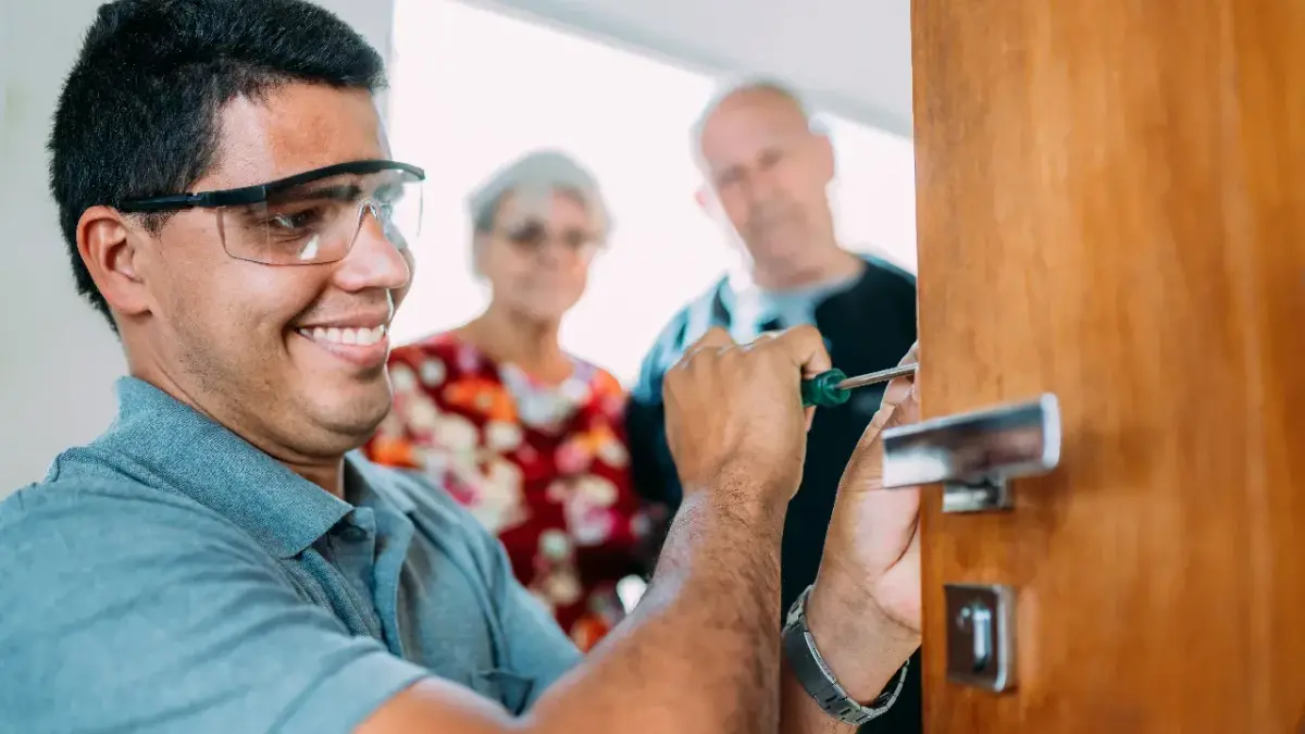 Licensed locksmith technician at a Lake Forest home front door with keys